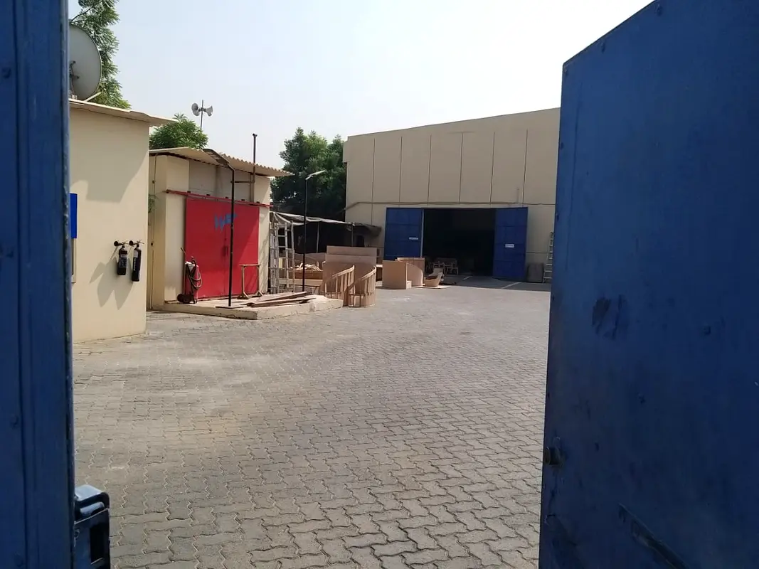 For sale in Industrial Area 10 \ on main Street  Walled land+2 warehouses+5 Rooms Labor camp+Offices