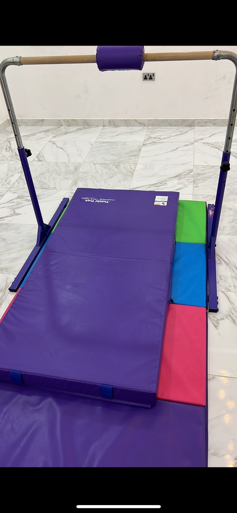 Gymnastics bar (by tumbl trak) with mats and bar pad