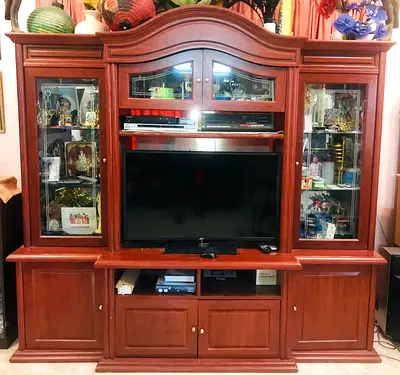 Wooden showcase cabinet with glass shelves and space for TV