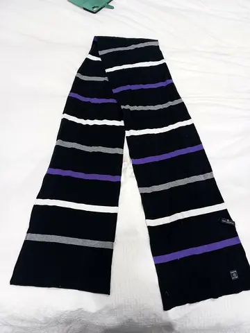 A long and wonderful striped scarf for women and men from the Ted Lapidus brand