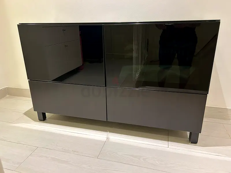 Black storage with 2 drawers and 2 door with glass on top