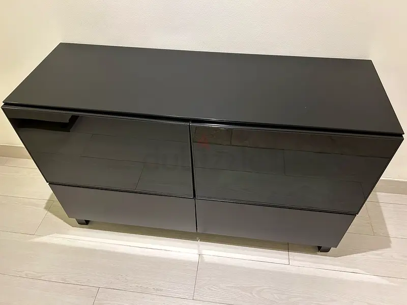 Black storage with 2 drawers and 2 door with glass on top