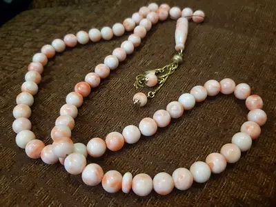 Vintage angel skin of coral rosary with solid gold tasel