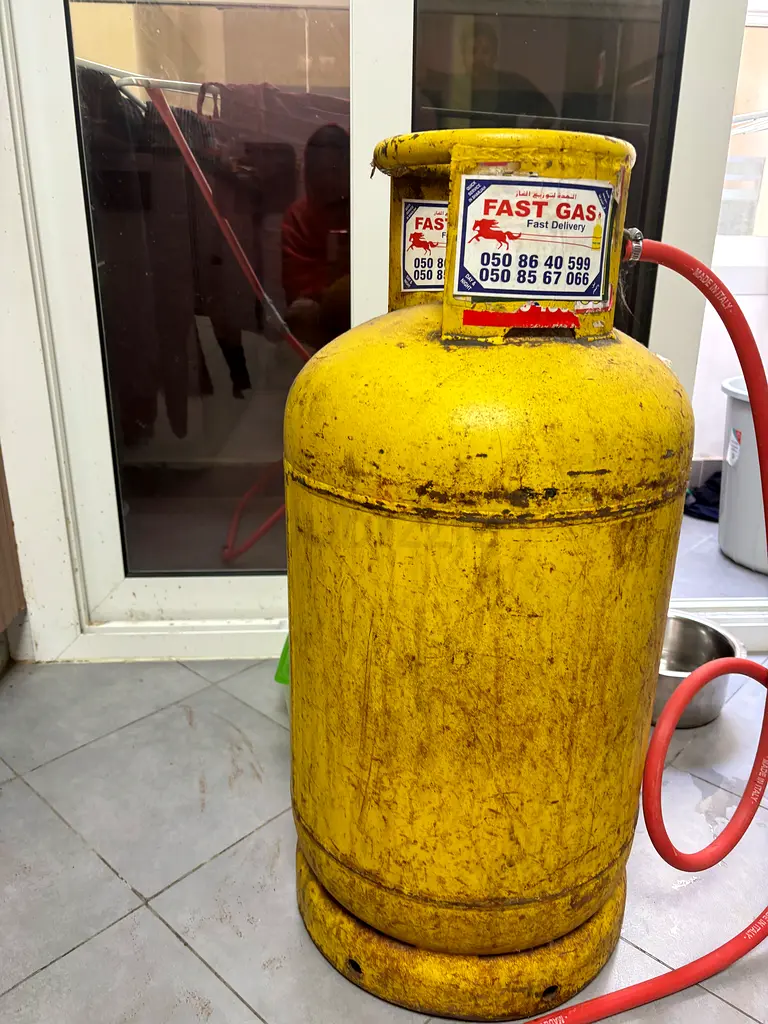 Gas stove with cast iron stove top and gas cylinder