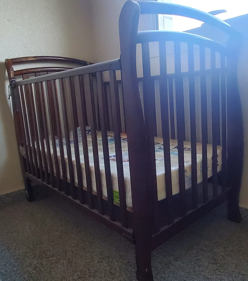 A beech wood bed with a new unused mattress and its accessories63206878311938112