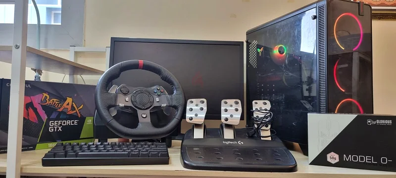 Gaming Pc Setup with Racing Wheel, Monitor, Keyboard, and Mouse.632296881011211129