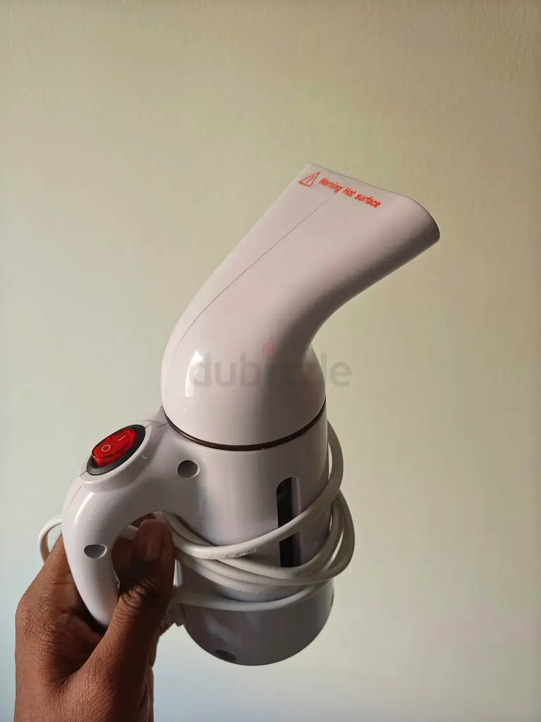 Hand held ironing machine
