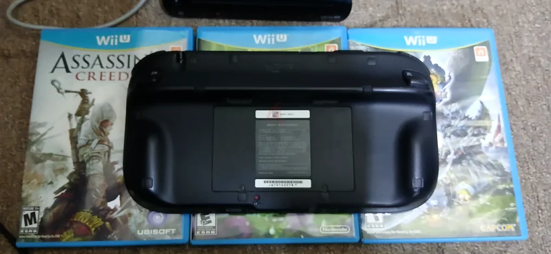 Nintendo Wii U console, black version with 32GB storage, comes with original adapters and three almost new games.63205880848257112