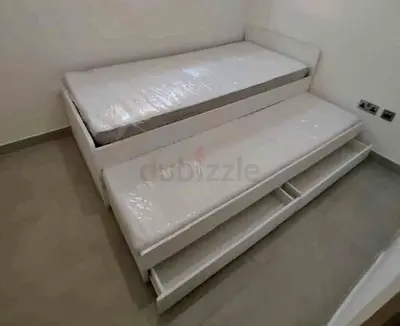 Slakt bed under bed with 2 Ikea mattresses and 2 storage drawers underneath .