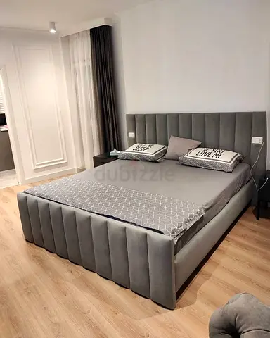Stylish Grey Upholstered Bed with Modern Design