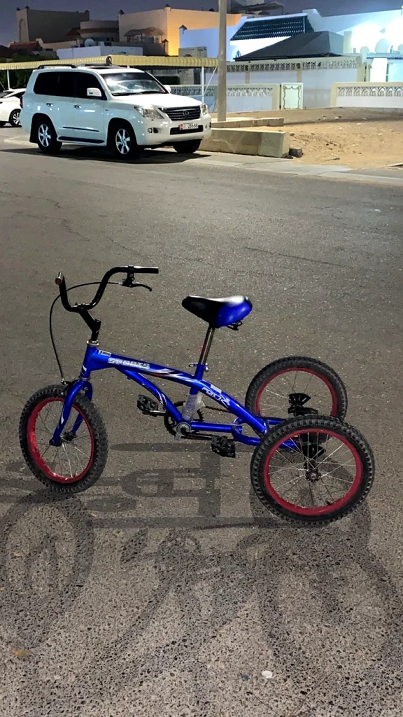 A blue three-wheeled bicycle.63245714652802112