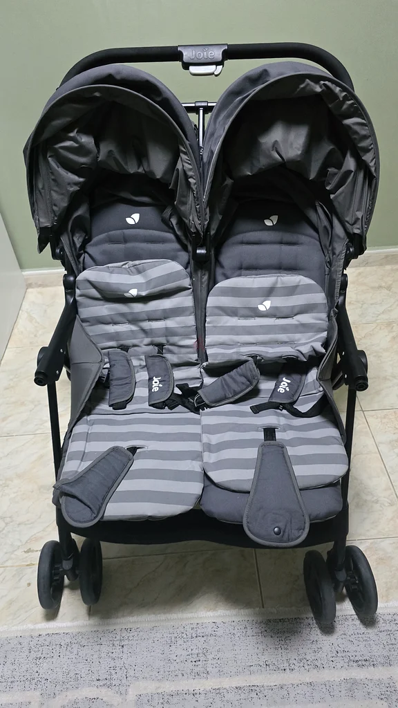 Arabic stroller for twins, 2 car seats for children, and a milk maker device.63176195845249111