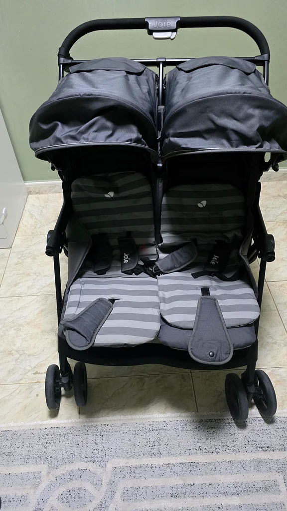 Arabic stroller for twins, 2 car seats for children, and a milk maker device.63176195845249113