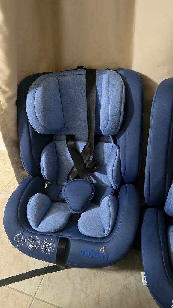 Arabic stroller for twins, 2 car seats for children, and a milk maker device.63176195845249114