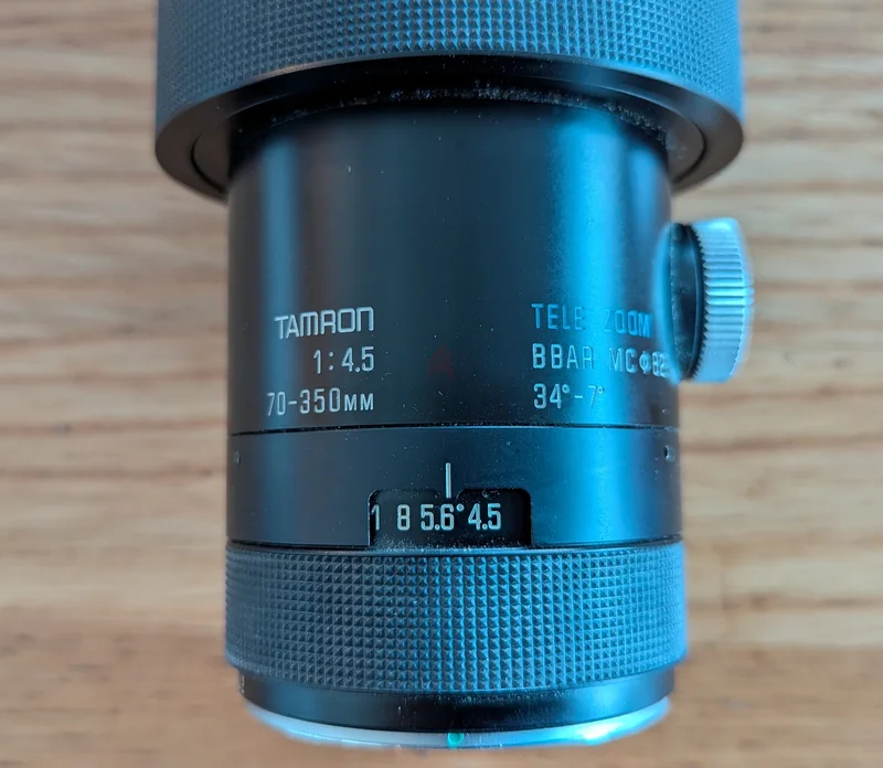 عدسة تيليفوتوغرافية للكاميرات من تامرون بقياس 70-350 مم f4.5 Adaptall 2 مع غطاء جلدي أصلي62934688776195114