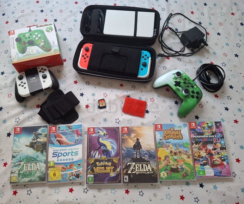 شاشة Nintendo Switch OLED مع 4 وحدات تحكم Joy-Con، ووحدتي تحكم، و7 ألعاب629356760364831113