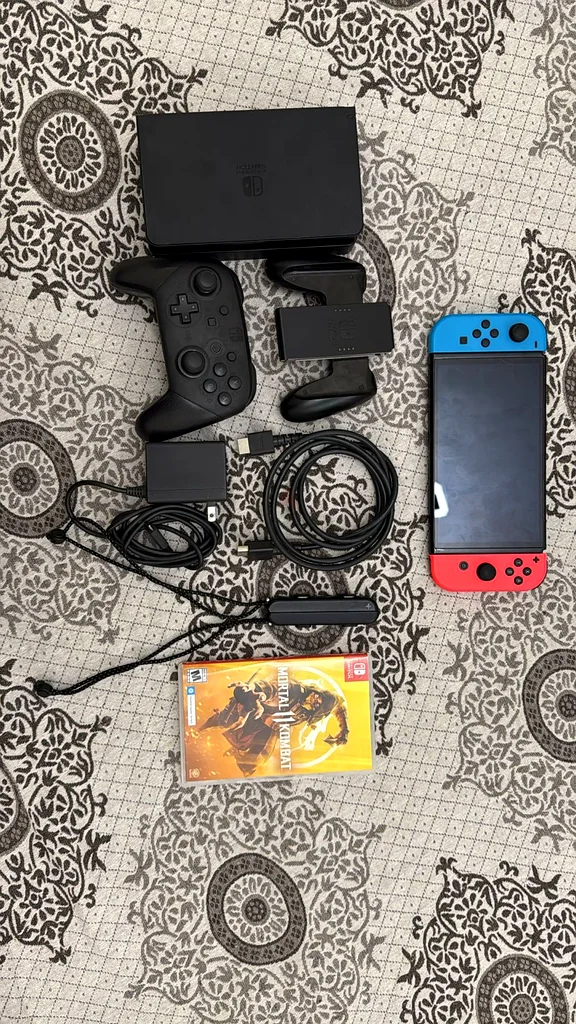 شاشة Nintendo Switch OLED مع جميع الملحقات ولعبة القتال المميتة والوحدة629356763128341124