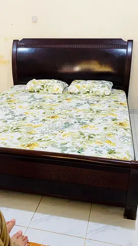 Elegant Wooden Bed Frame with Floral Mattress