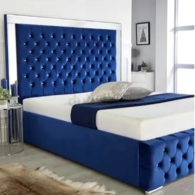 Luxurious Blue Velvet Bed with Elegant Headboard