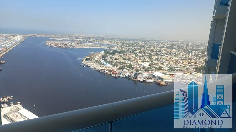 For sale, in installments, in oasis Towers, Ajman, a two-bedroom apartment with a full water view of Ajman Creek.63888048116739111