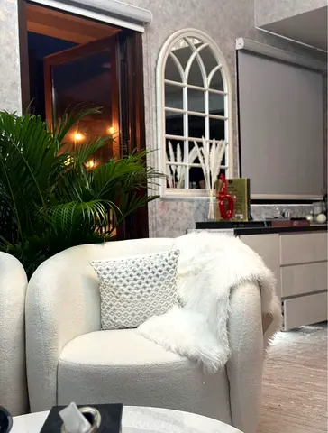 Cozy White Armchair with Stylish Throw
