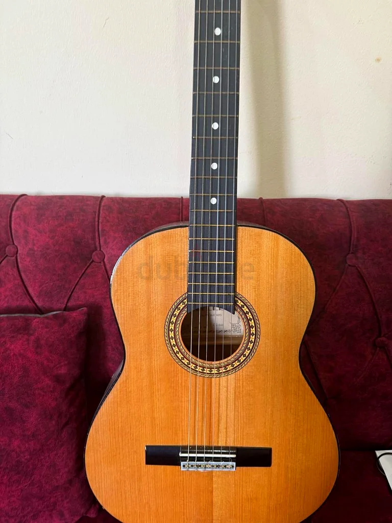 2 wooden guitars, one small and one large632296838805771111