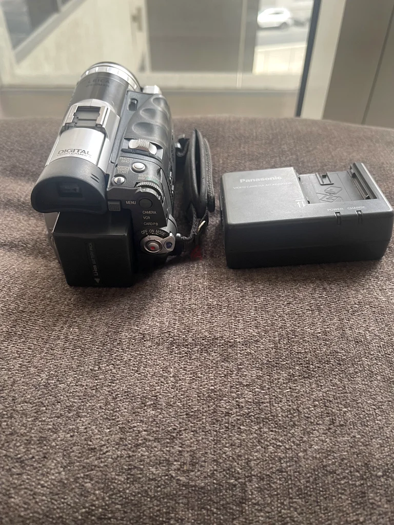 Panasonic NV-GS70 miniDV Camcorder along with its AC adaptor/charger.63234126032898113