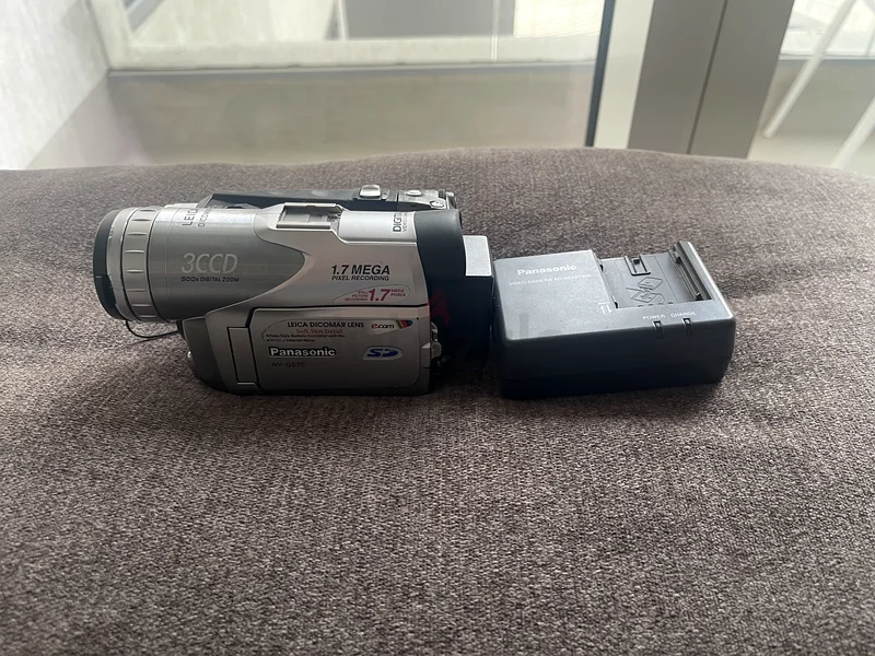 Panasonic NV-GS70 miniDV Camcorder along with its AC adaptor/charger.63234126032898110