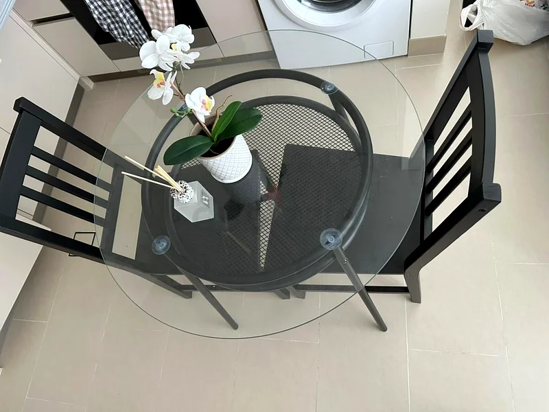 طاولة طعام زجاجية أنيقة مع كراسي سوداء63179863706755111