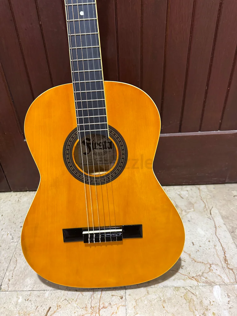 Two wooden guitars, one full size and one smaller educational size for children, in excellent condition, almost new, plus 2 extra sets of strings as a gift63229302005634111