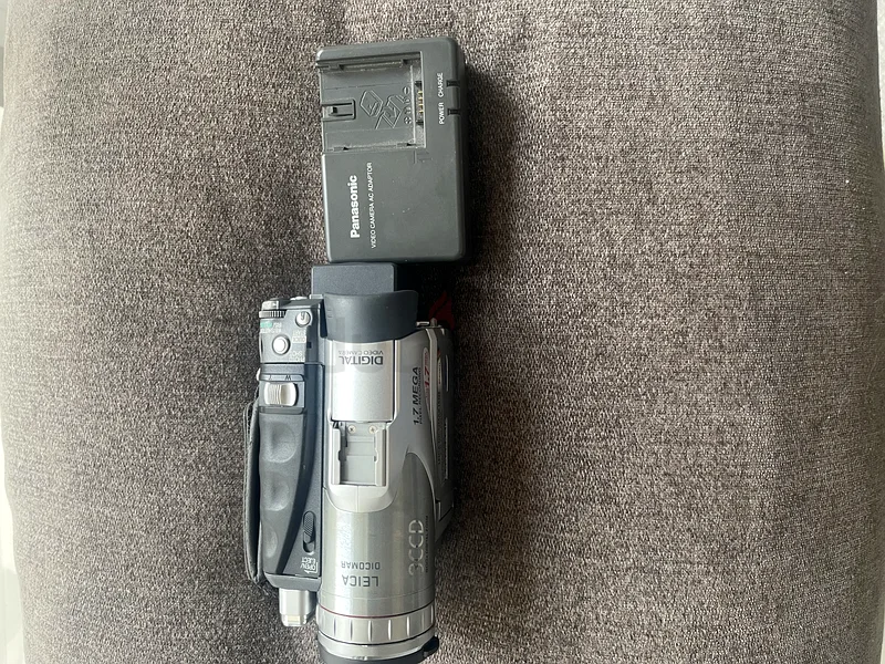 Panasonic NV-GS70 miniDV Camcorder along with its AC adaptor/charger.63234126032898111