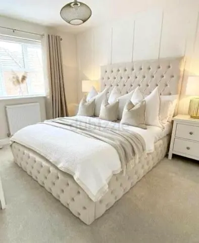Luxurious Cream Upholstered  Bed with Plush Pillows