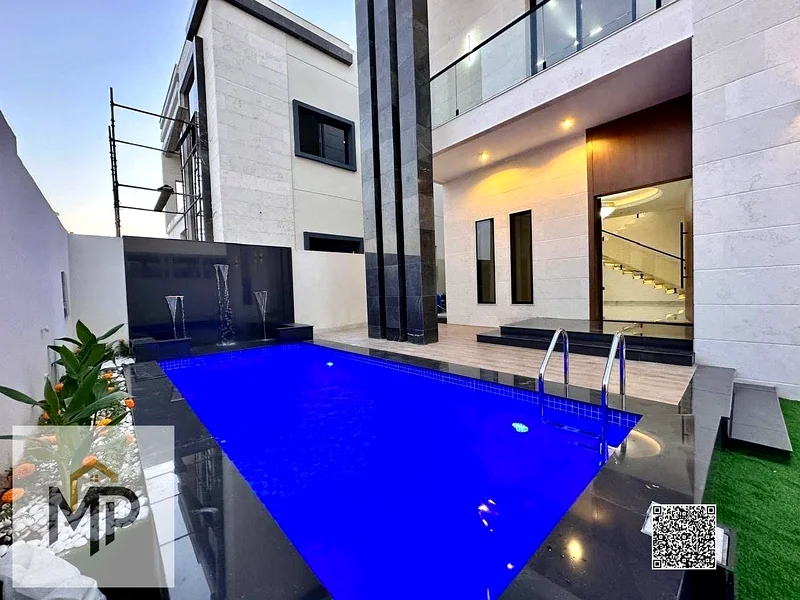 For sale - a luxury villa with a swimming pool in a prime location in Ajman, high-end finishing, modern design, including registration and swimming63897419956355111
