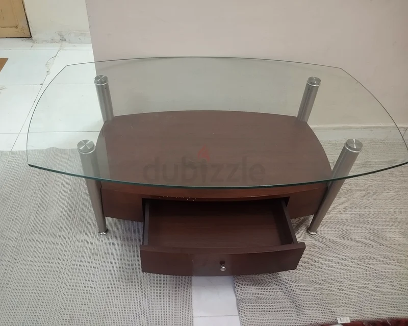 A modern wooden and strong glass table suitable for TV or multipurpose living room use, featuring a drawer.63187703355649111
