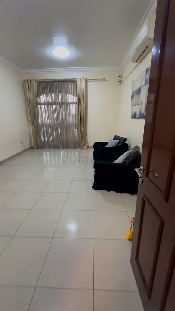 A large room with a balcony overlooking Khalifa.63143497290498112