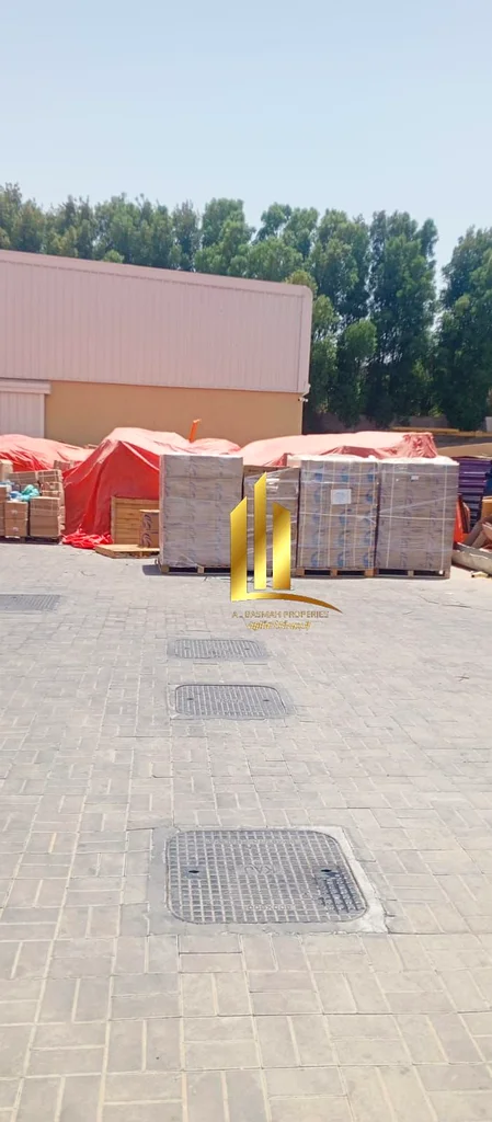 Investment property for sale in Al Sajaa Industrial area, consisting of a yard + a large warehouse + 2 shops in the front. The property is only two mo63195059689730113