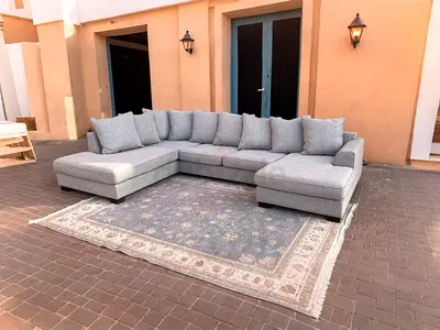 The One Elegant U-Shaped Sofa with Beautiful Rug - Perfect for Your Living Space!