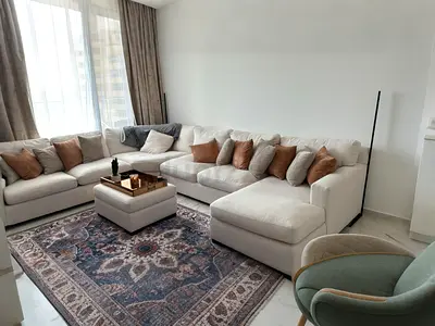 Elegant L-Shaped Sofa with Coffee Table and Vintage Rug