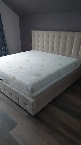 Elegant King-Size Bed with Plush Headboard