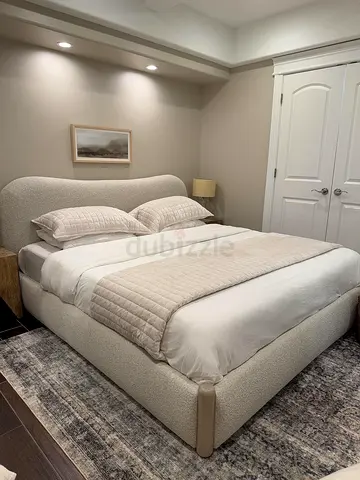 Luxurious Cream Upholstered Bed with Cozy Bedding