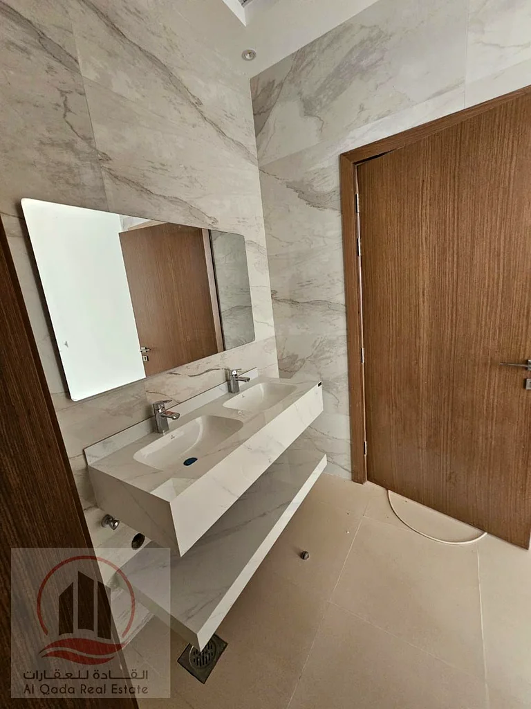 Villa for sale, including central air conditioning, in Ajman Al Bahia, 5 master bedrooms, a living room, a maid's room, freehold for all nationalities63883087705730114