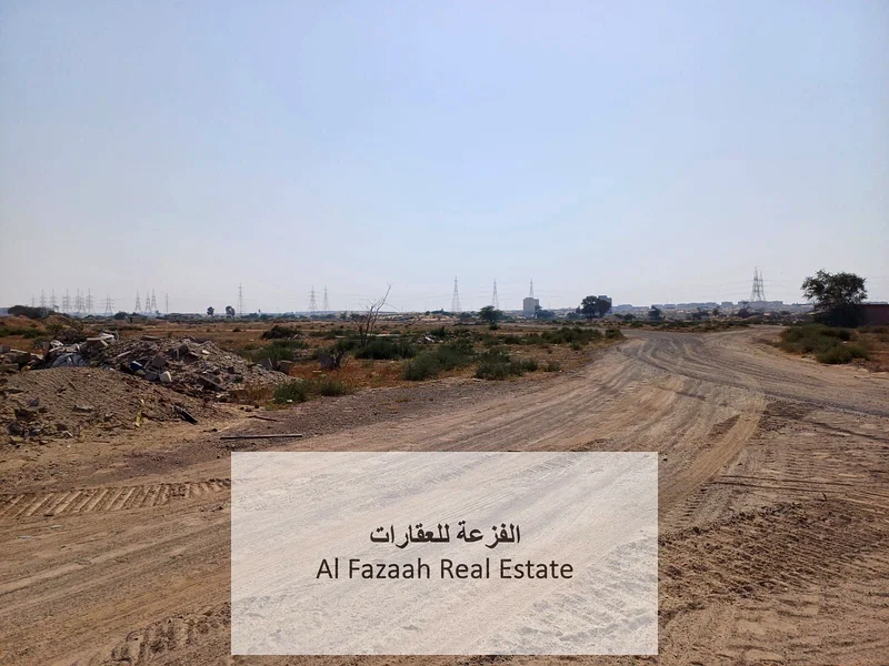 For sale in Sharjah, Al Qasimia City, Nizwa, vacant land, area 11,948 square feet, industrial permit, freehold warehouses for all nationalities, excel63821147173762110