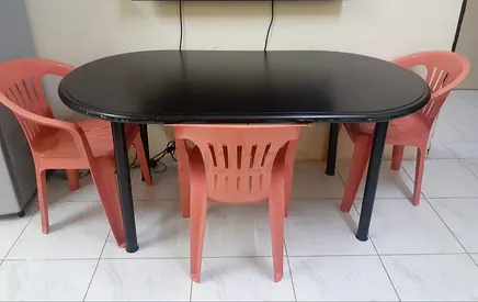 Chic Black Dining Table with Colorful Plastic Chairs