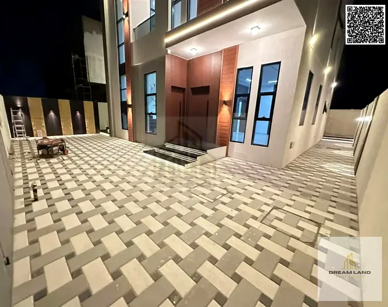 For sale, a villa consisting of 4 master bedrooms, a living room, and 2 halls, including registration fees, in Ajman, Al Helio 2 area63891458503425112