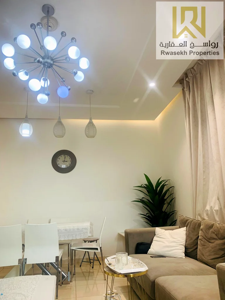 Real estate investment opportunity in Orient Towers, Ajman - 2 bedroom and hall apartment for sale with easy monthly installment plan.63866727827714110