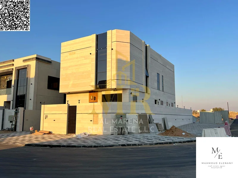 For Sale – Luxury Corner Villa in Al Helio 2 – Ajman | 5 Master Bedrooms + Majlis & 2 Halls + Modern Kitchen + Full Central AC | Main Road & Close to63898440155779112