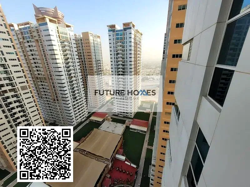 شقة مطبخ مغلق 2 غرفة نوم للبيع في برج عجمان وان مع موقف سيارات63888159714690110