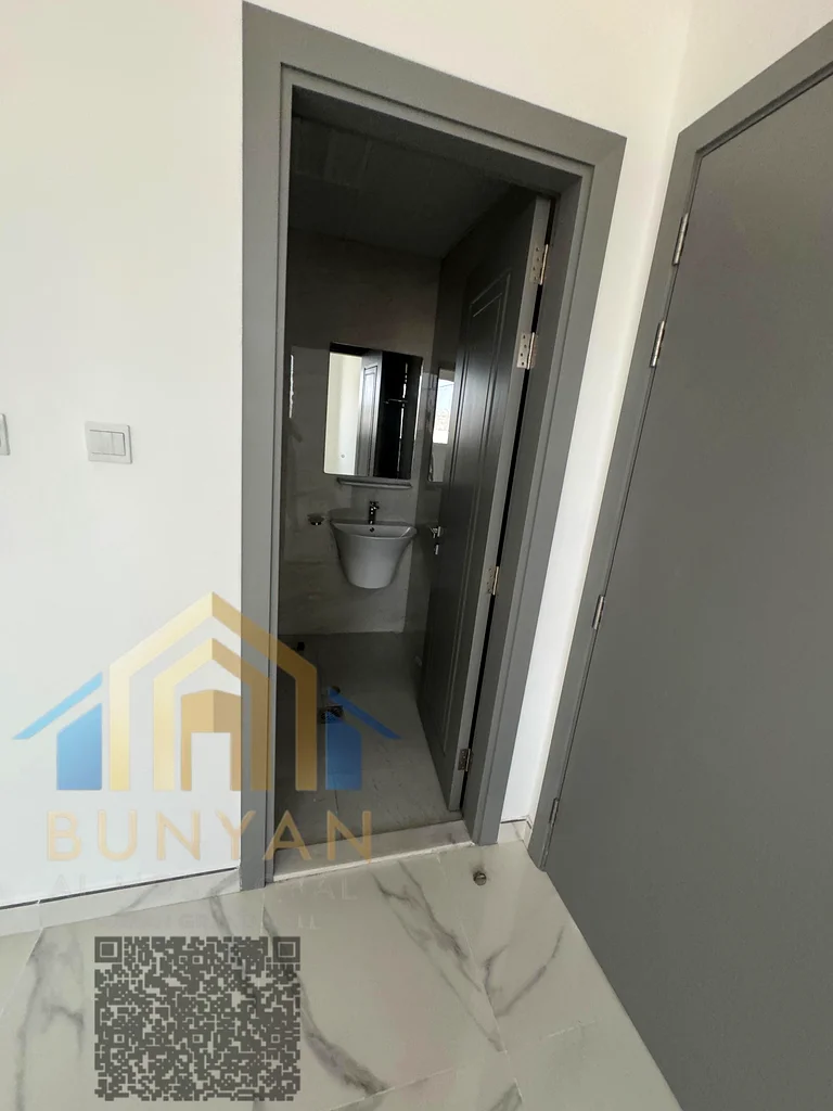 Apartment for rent in Al Rashidiya 2, Ajman, featuring 2 bedrooms, hall, 2 bathrooms, balcony, and central A/C. Prime location near Ladies Park. Annua63721053688322113