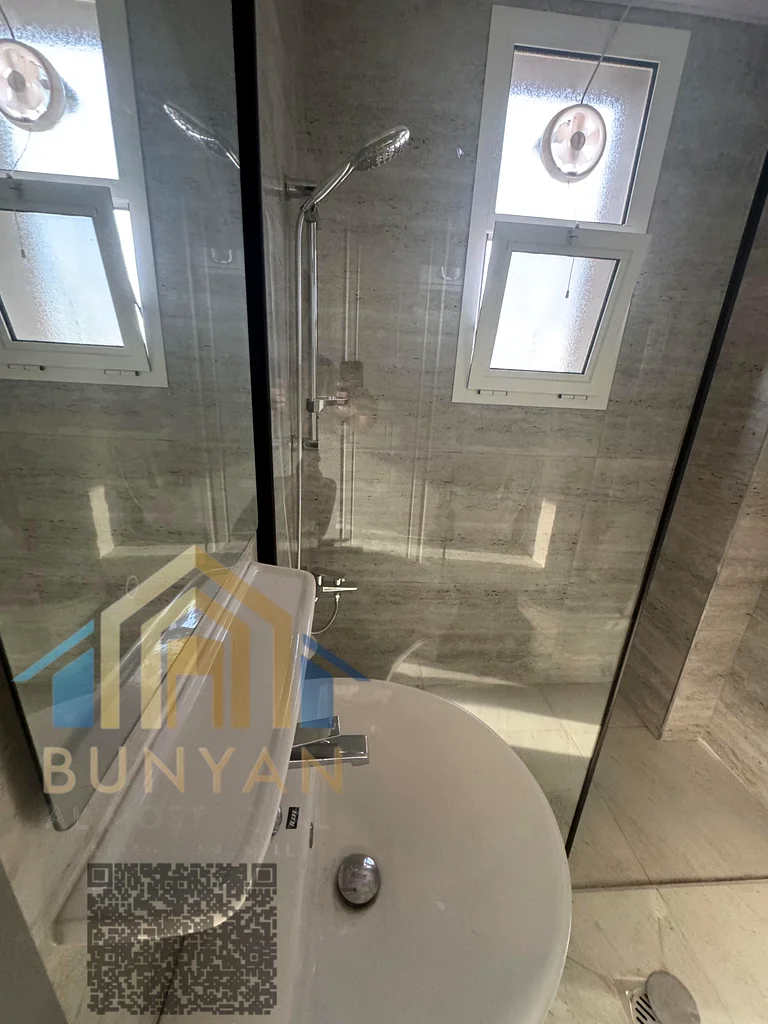 Apartment for rent in Al Rashidiya 2, Ajman, featuring 2 bedrooms, hall, 2 bathrooms, balcony, and central A/C. Prime location near Ladies Park. Annua63721053688322110