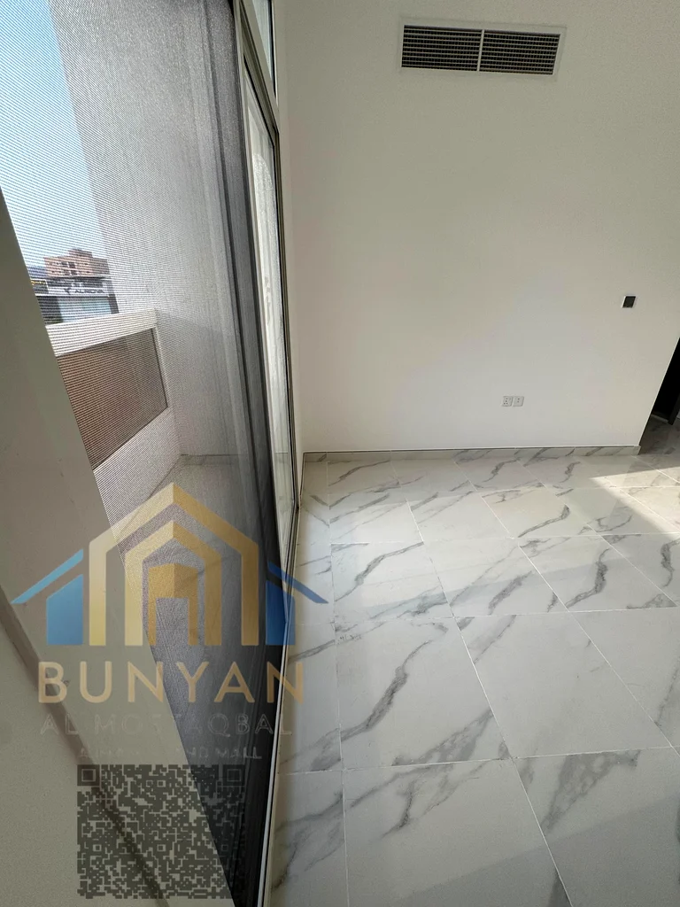 Apartment for rent in Al Rashidiya 2, Ajman, featuring 2 bedrooms, hall, 2 bathrooms, balcony, and central A/C. Prime location near Ladies Park. Annua63721053688322112